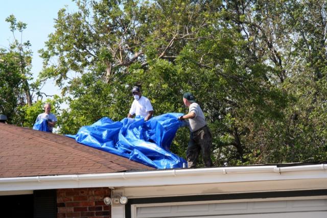 Team members' tarping the roof 