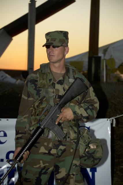  Pvt. Patrick Lane of the Washington State National Guard stand guard at a PRC Compassion Aid Station in New Orleans. 
