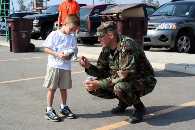 A National Guardsman talks to a little boy. God Bless America. 