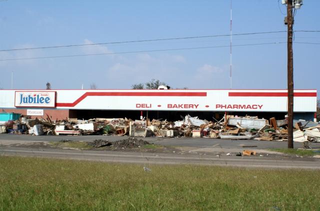 This grocery store was cleaned out by using a skid loaded to knock out the front windows and pushing the debris into the parking