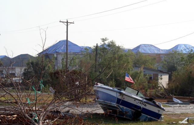  This boat named tsunami ended up on shore… Note the FEMA Blue Tarped roofs in the background in Slidell, LA 