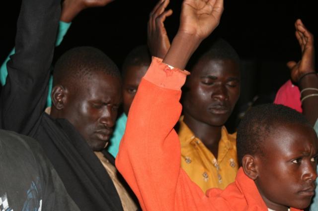 The Men of Eldoret praying during the Crusade 