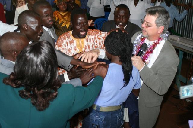 The Pastors and Elders lay hands on and prays for healing for this child