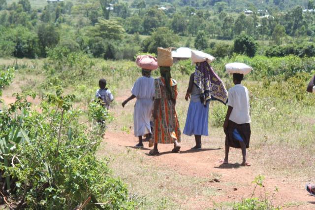 The woman of Homa-bay start making their way home carrying a weeks worth of food for their families 
