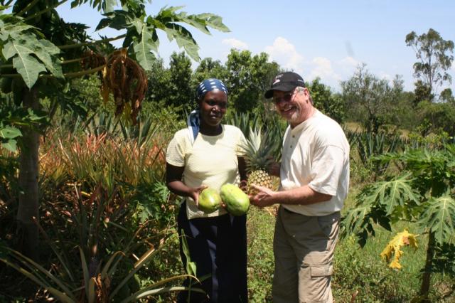 This woman gives Pastor Terry a gift of thanks a pineapple and papayas from her garden 