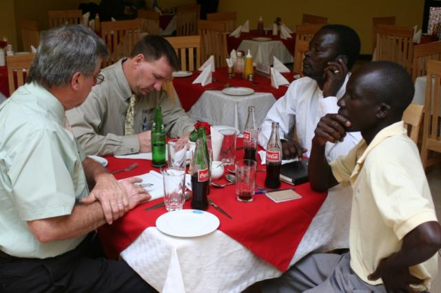 Pastor Terry, David Campbell, Pastor Mathew and contractor Eric discuss possible plans for building an orphanage in Eldoret 