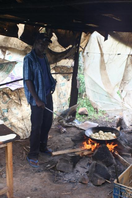  A Church neighbor fries up some "doughnuts" like sweet bread (maandazi) for the next days market 