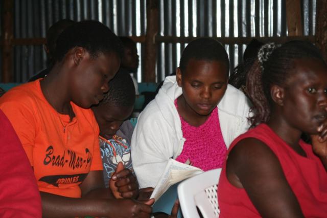 Mary Wamboi (center) takes notes during the conference at Hope of Salvation church 