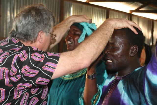 Pastor Terry anoints and prays for Pastor Mathew and his wife Becky 