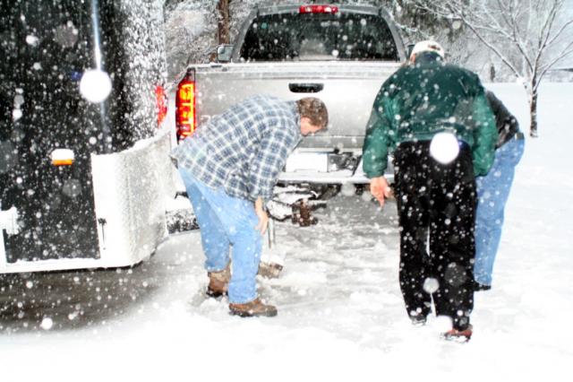Team members hitch up the trailer loaded with 900 Christmas gifts and other relief supplies. 