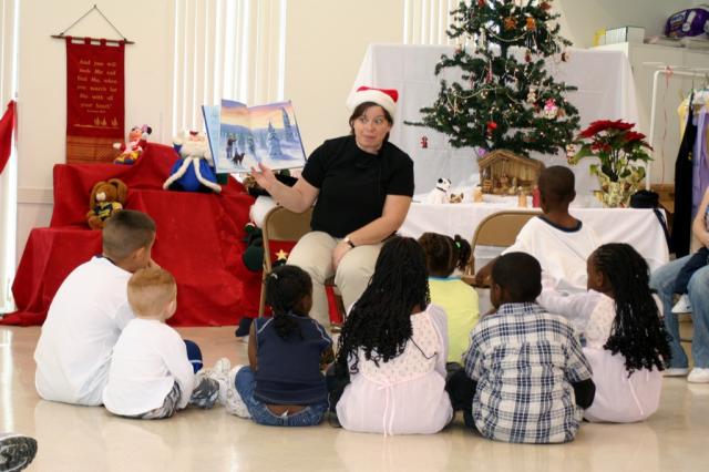 Michele Kabay reading the Christmas Story to the kids at the party in Metairie, LA. 
