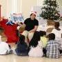 Michele Kabay reading the Christmas Story to the kids at the party in Metairie, LA. 