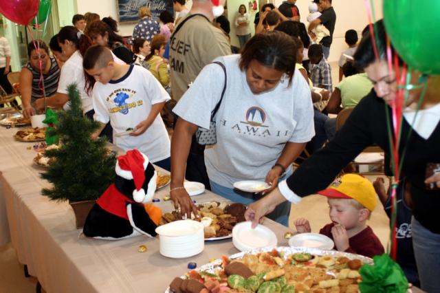Residents take cookies during the party in Metairie. 