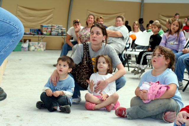  A family looks on as they listen to the Christmas story. 