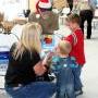 Team member Richard Schall (center) helps a family open their gifts. 