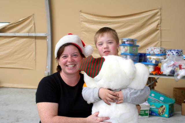 Michele talks to the little boy who just got a terry bear for his gift. 