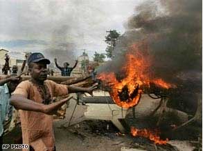 Opposition party supporters gather around a burning barricade in Kisumu, western Kenya.