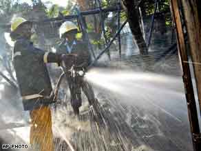 Firemen work to extinguish a fire at a Pentecostal church which was set ablaze in Eldoret, Kenya