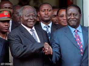 Kenya's President Mwai Kibaki, left, shakes hands with opposition leader Raila Odinga on 25 Jan 2008