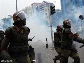 Police officers fire tear gas to chase Orange Democratic Movement supporters in Nairobi.
