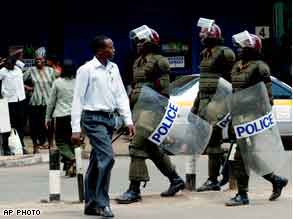 Riot police patrol the streets of Nairobi.