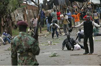 Opposition supporters taunt police during riots in the Nairobi slum of Kibera