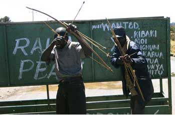 Opposition supporters brandish their bows at a roadblock on the route to Eldoret. Tim Cocks Reuters.