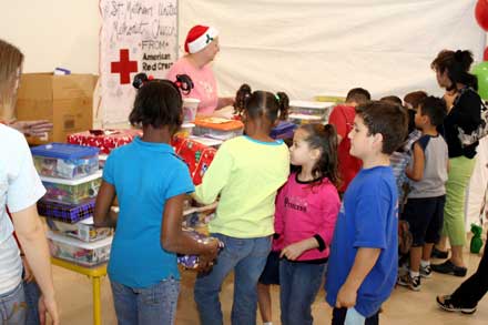 The kids receive their Christmas gifts. Photo by Michael Kabay Christmas_at_StMatthews